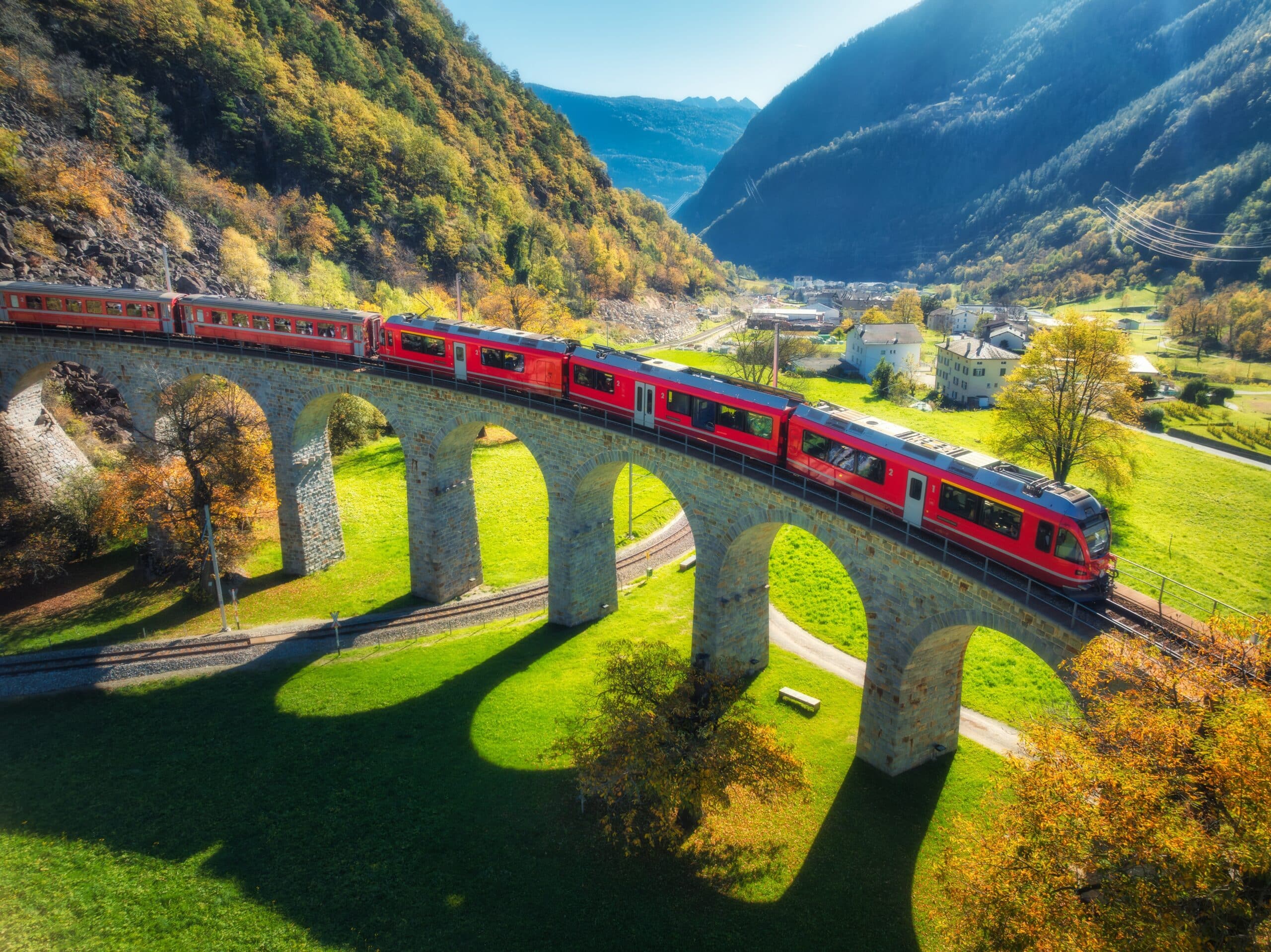 Aerial,View,Of,Red,Train,On,Kreisviadukt,In,Alpine,Mountains